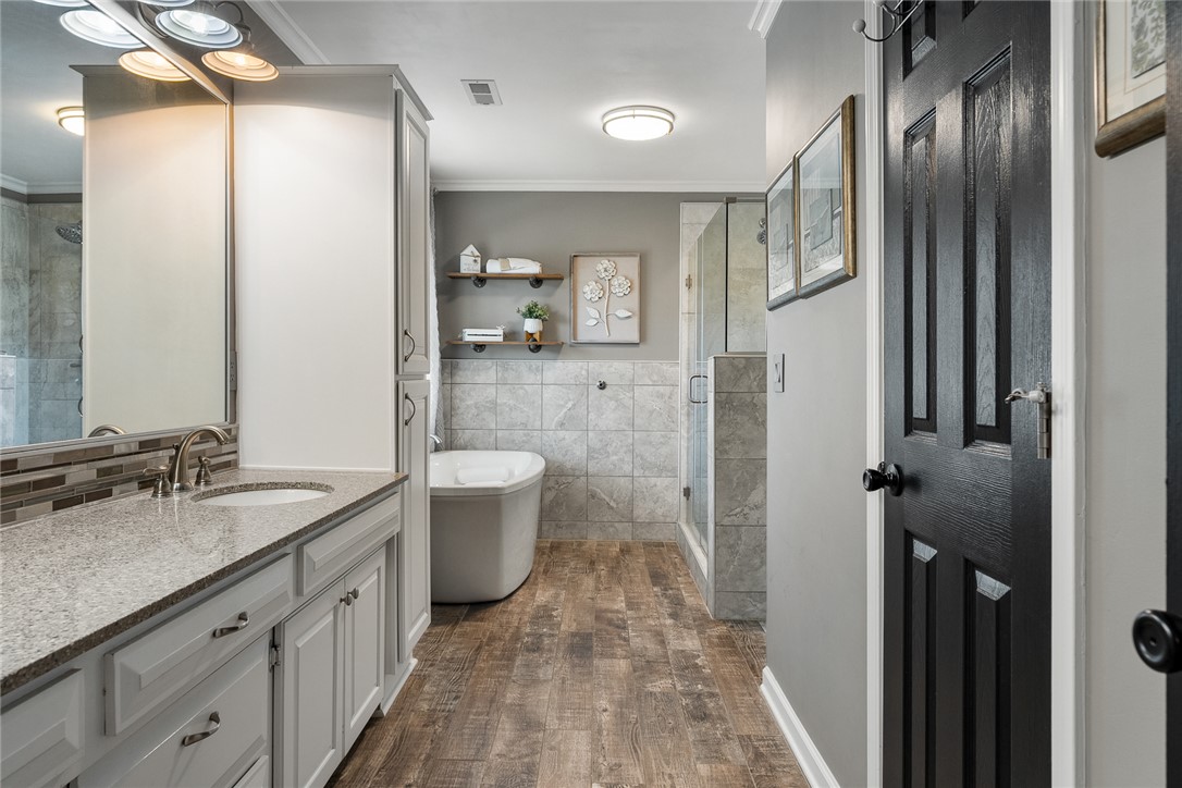 112 C-10-220 Anderson, SC 29621 - Photo 27 of 45 This modern bathroom features a sleek vanity, an elegant soaking tub, and a spacious glass-enclosed shower.