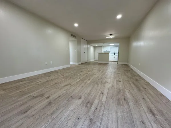 a view of a room with wooden floor and window
