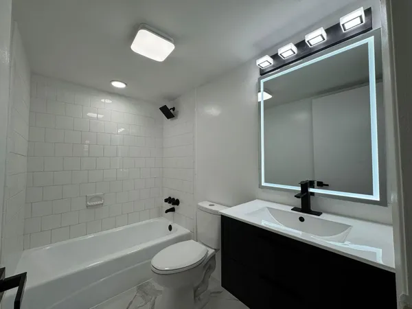a bathroom with a sink toilet a bathtub and shower
