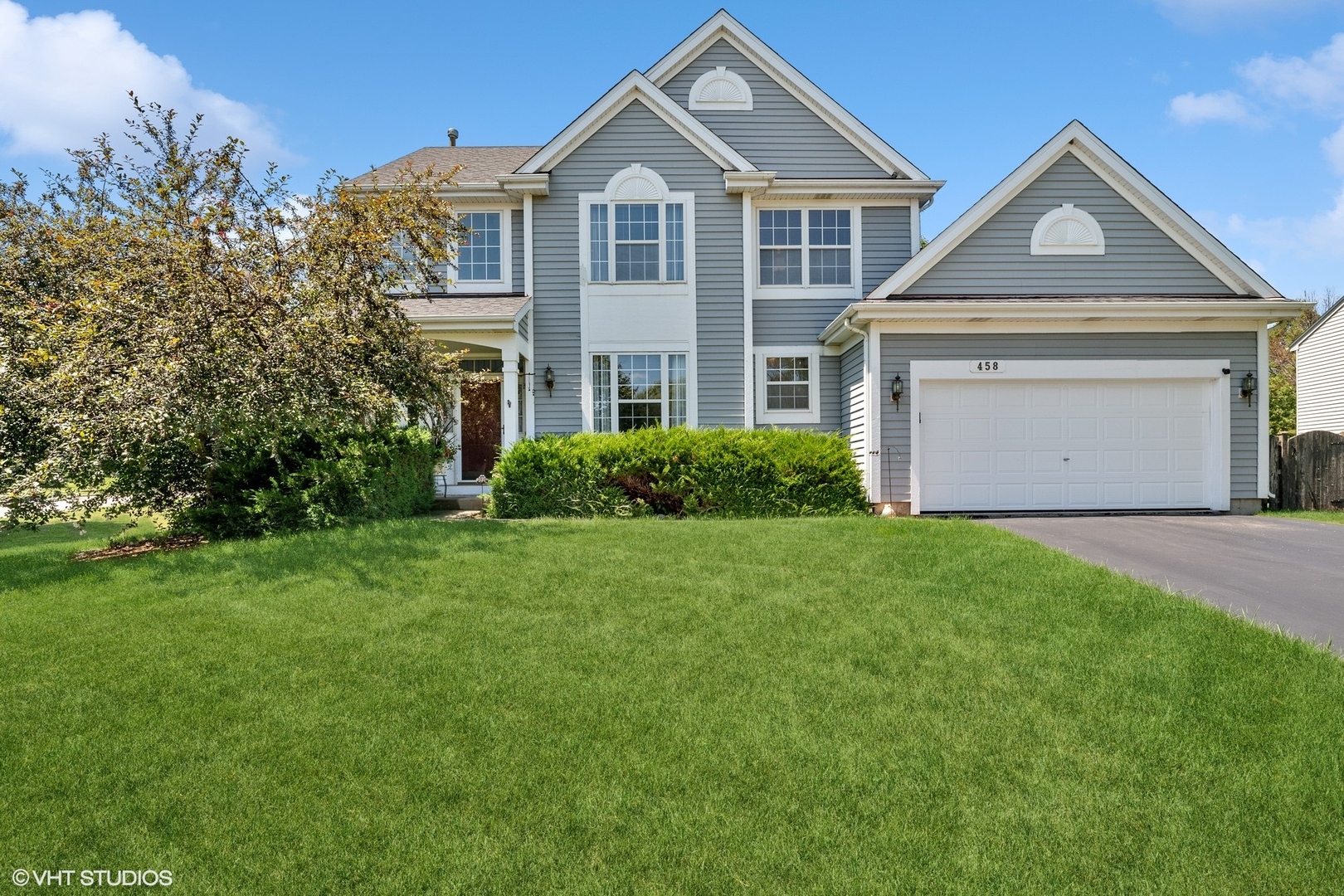 a front view of a house with a yard and garage