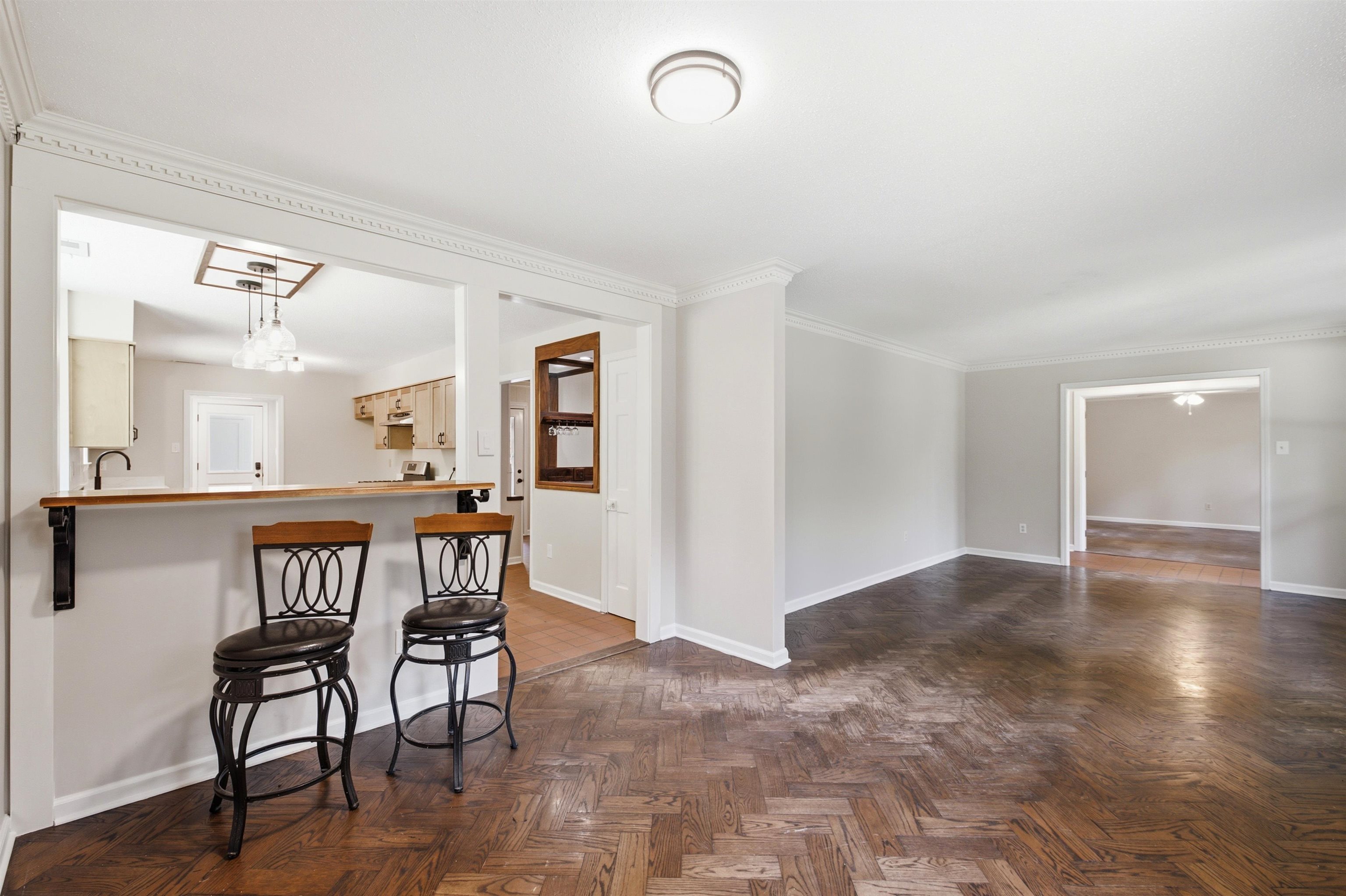 1370 North Reid Hooker Road Eads, TN 38028 - Photo 18 of 39 Spacious living area featuring herringbone wood-finish flooring and crown molding