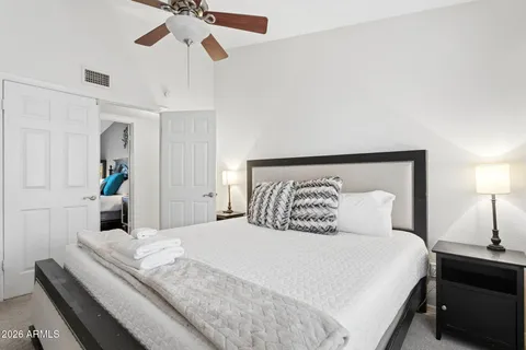 a bedroom with a bed and a chair