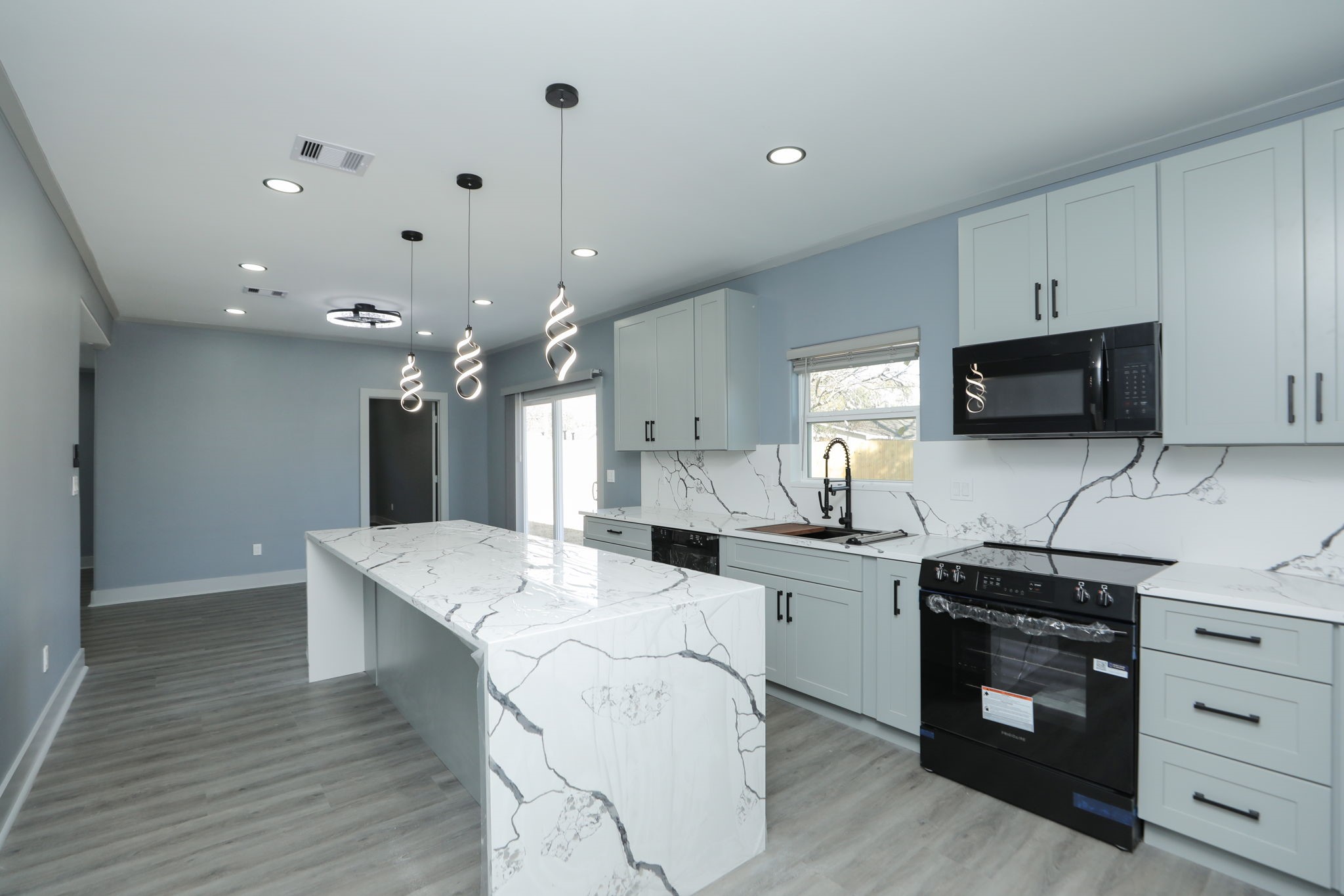 4047 Juliet Street Houston, TX 77087 - Photo 16 of 38 a kitchen with a sink stove and microwave