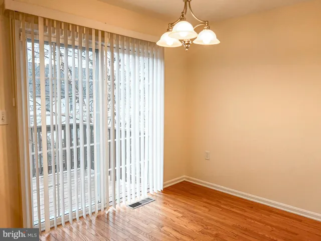 a view of a chandelier fan and wooden floor