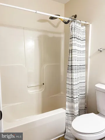 a bathroom with a toilet and shower