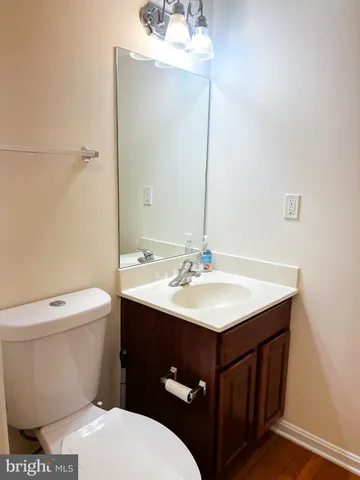a bathroom with a sink vanity mirror and toilet