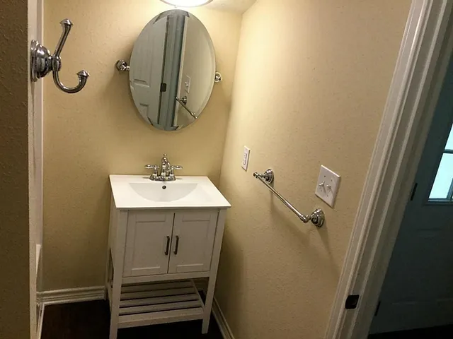 a bathroom with a sink and mirror