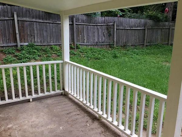 a view of a backyard with wooden fence