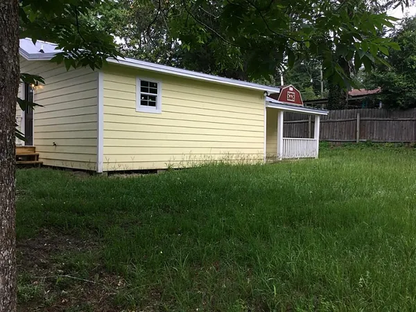 a view of a house with a backyard