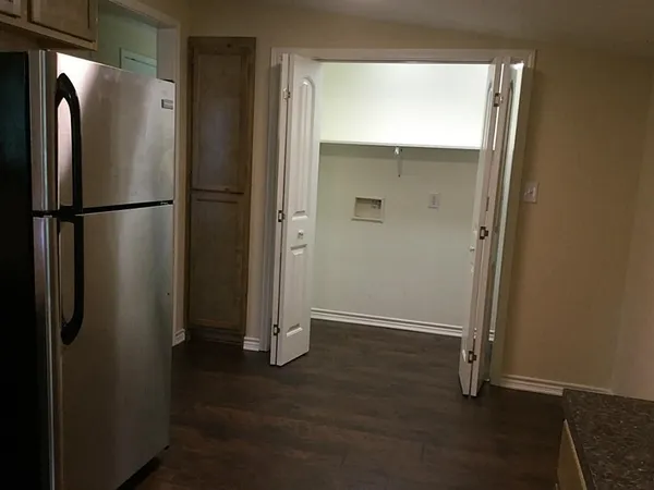 a view of a room with wooden floor