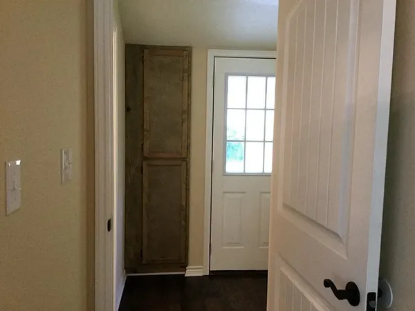 a view of front door with wooden floor