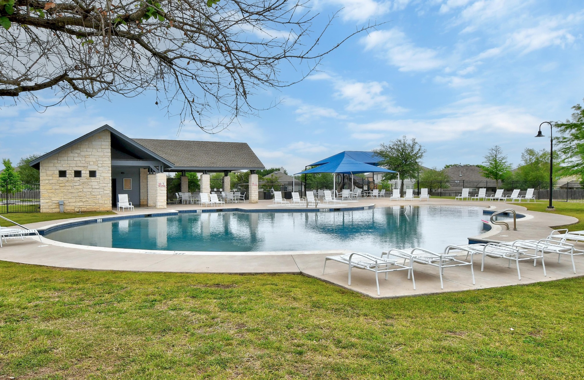 877 Hot Spring Valley Buda, TX 78610 - Photo 28 of 36 a view of a swimming pool with a table and chairs under an umbrella