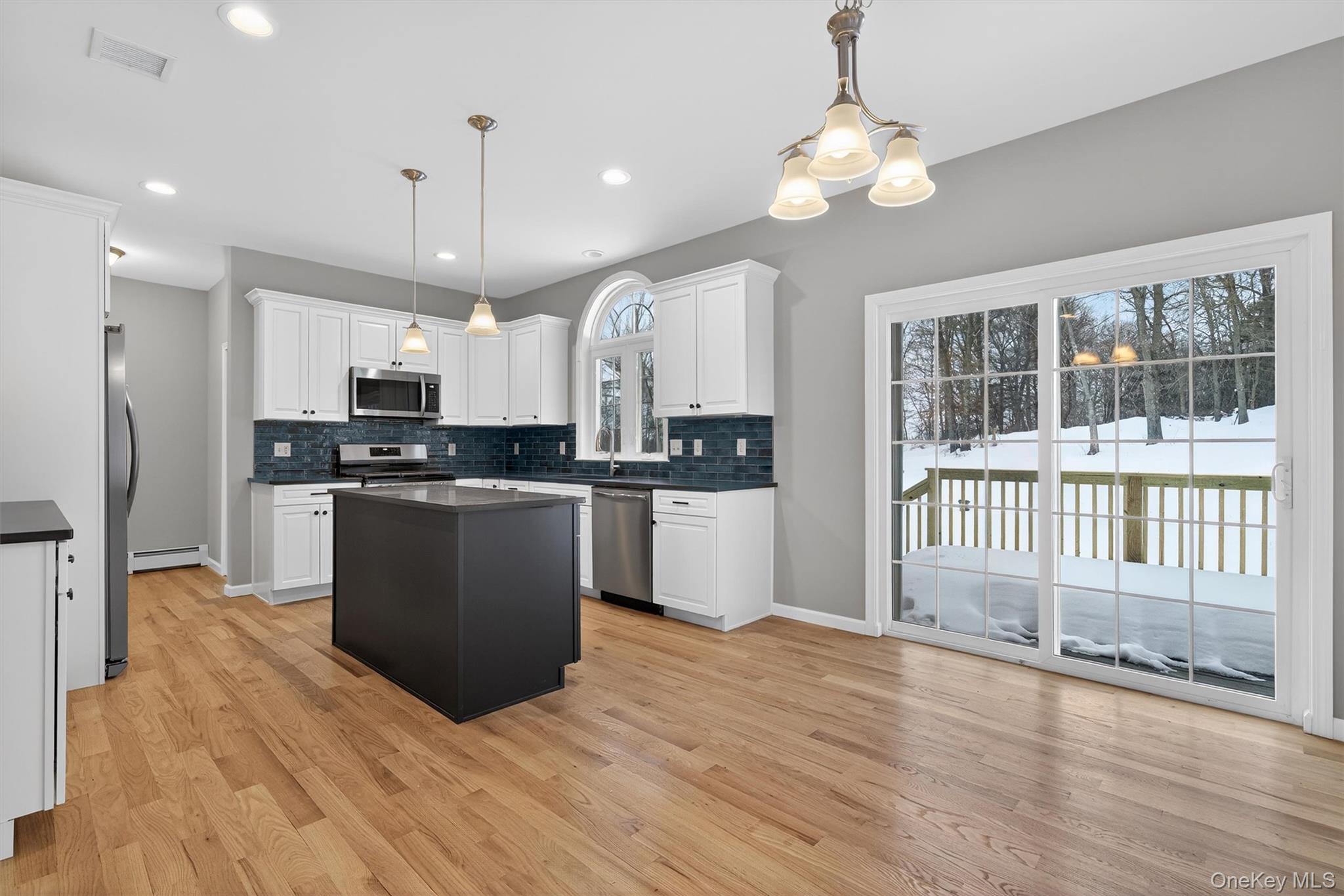 509 Toleman Road Rock Tavern, NY 12575 - Photo 13 of 36 a kitchen with granite countertop a stove top oven a sink and cabinets