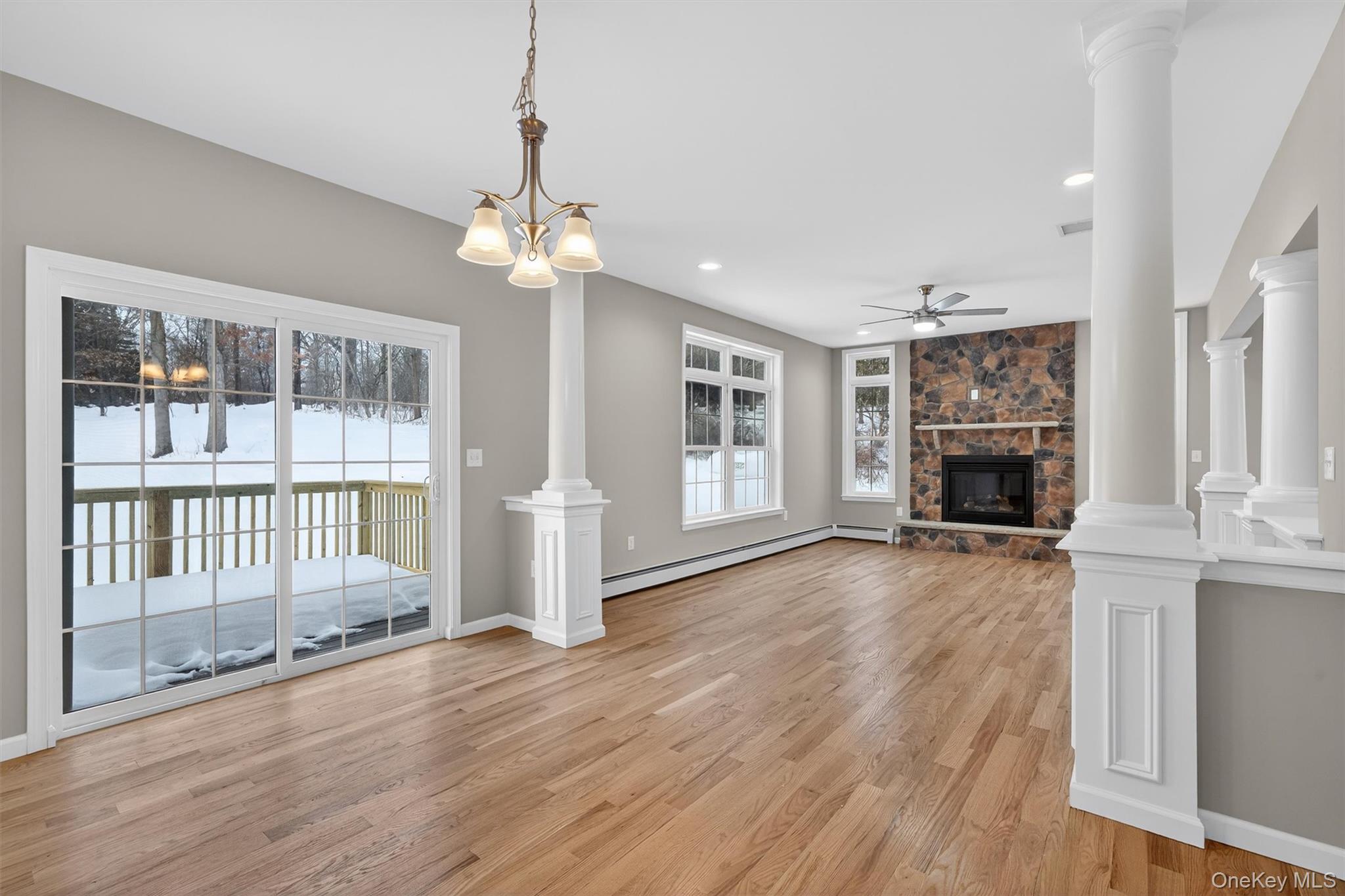 509 Toleman Road Rock Tavern, NY 12575 - Photo 15 of 36 a view of a livingroom with wooden floor fireplace and windows