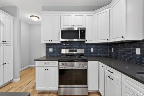 a kitchen with appliances a sink and cabinets