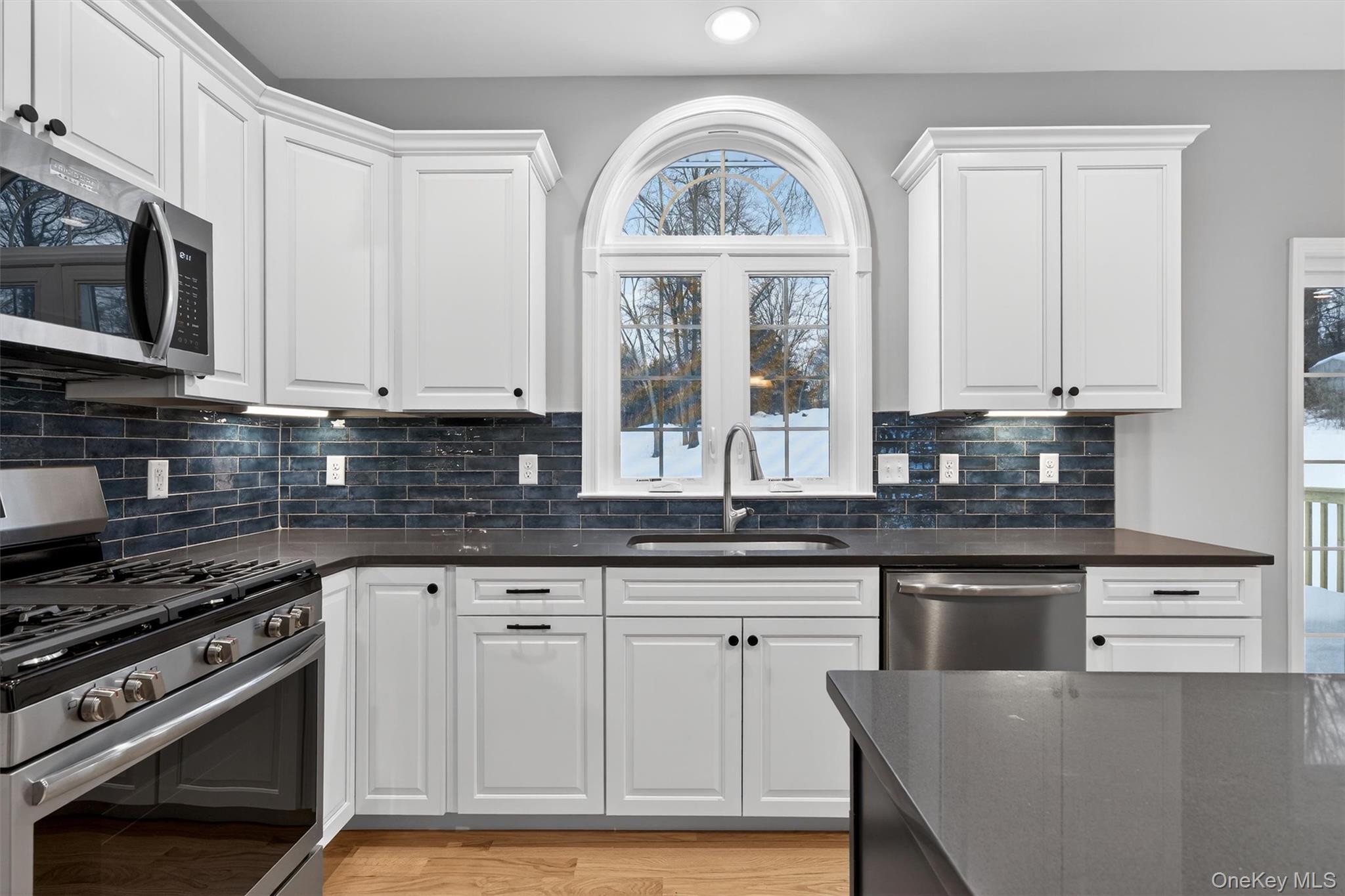 509 Toleman Road Rock Tavern, NY 12575 - Photo 19 of 36 a kitchen with stainless steel appliances granite countertop a stove a sink and a microwave