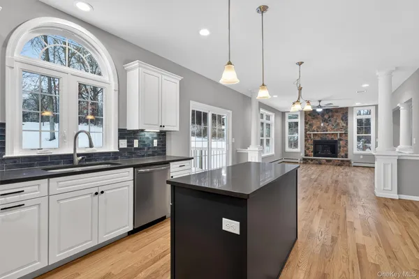 a kitchen with sink stove and wooden floor