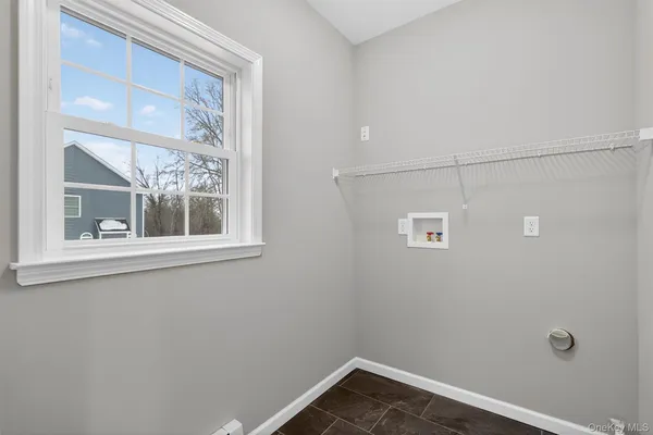 a view of a small space with wooden floor and a window