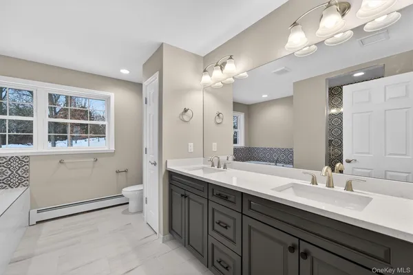 a bathroom with a sink double vanity and a mirror