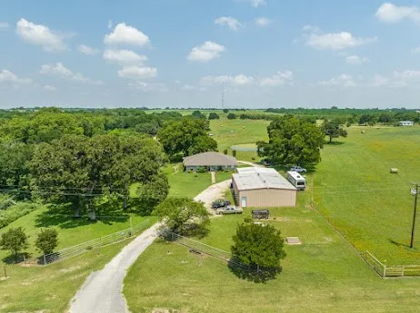 a view of a patio with a table and chairs and potted plants
