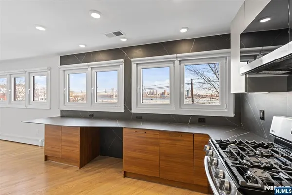 a kitchen with stainless steel appliances granite countertop a stove and a sink