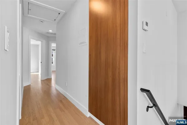 a view of a hallway with wooden floor
