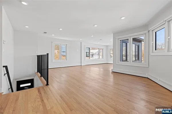 a view of a livingroom with wooden floor and furniture