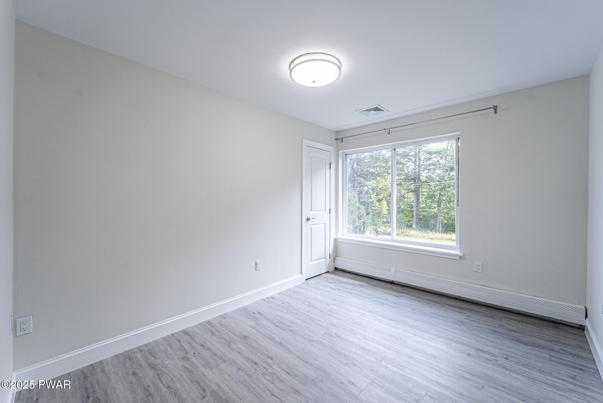 153 Hatton Road Hawley, PA 18428 - Photo 17 of 38 an empty room with wooden floor and windows