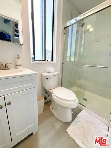 a bathroom with a toilet sink and a mirror