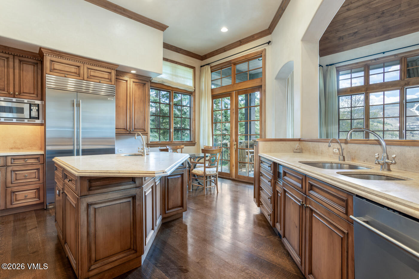 312 Holden Road Beaver Creek, CO 81620 - Photo 18 of 45 a kitchen with a stove a sink a refrigerator and wooden cabinets