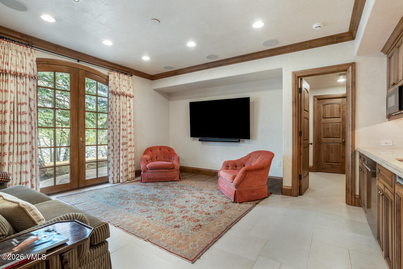 312 Holden Road Beaver Creek, CO 81620 - Photo 31 of 45 a living room with furniture a flat screen tv and floor to ceiling window