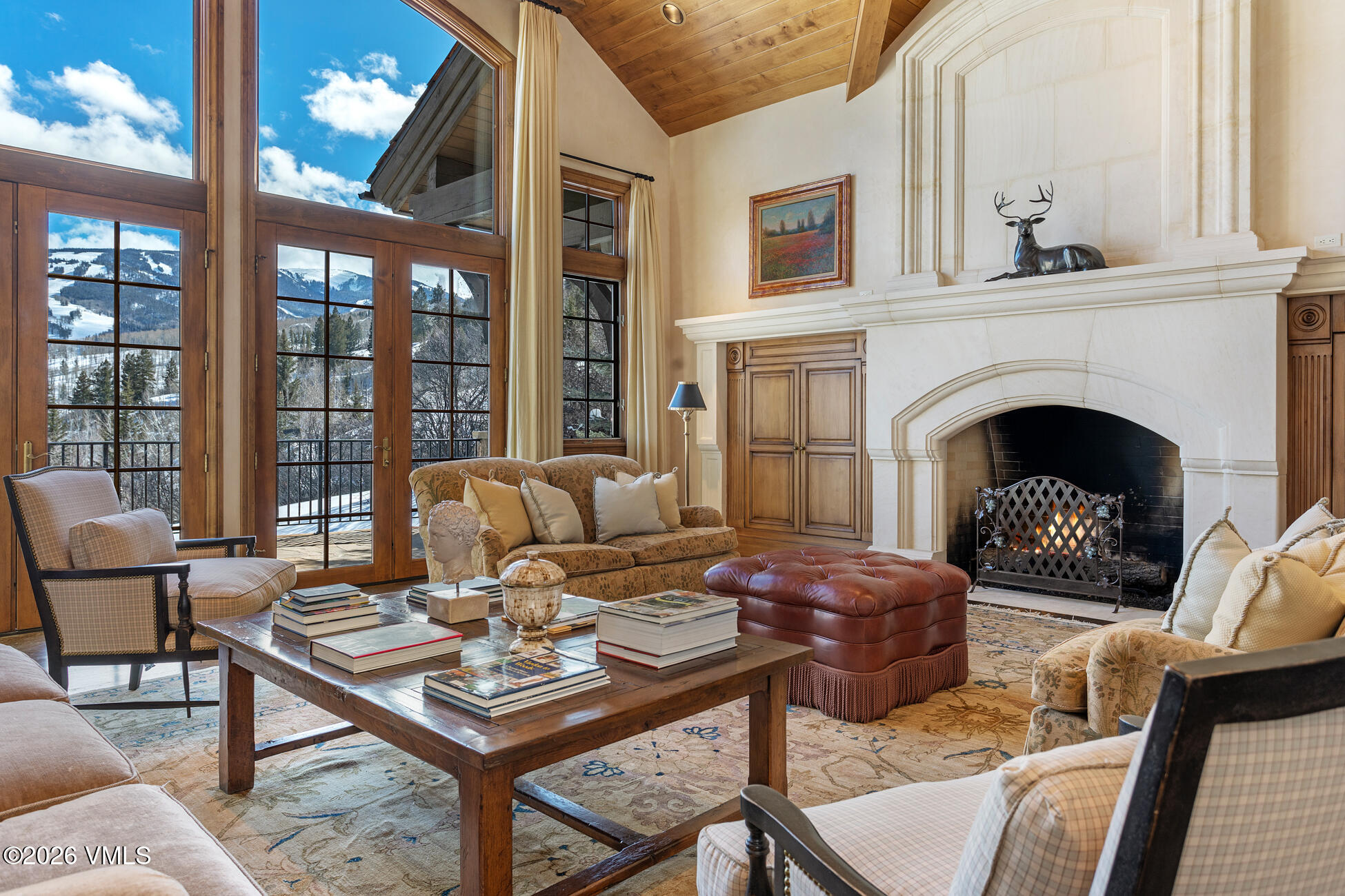 312 Holden Road Beaver Creek, CO 81620 - Photo 4 of 45 a living room with furniture a fireplace and a floor to ceiling window