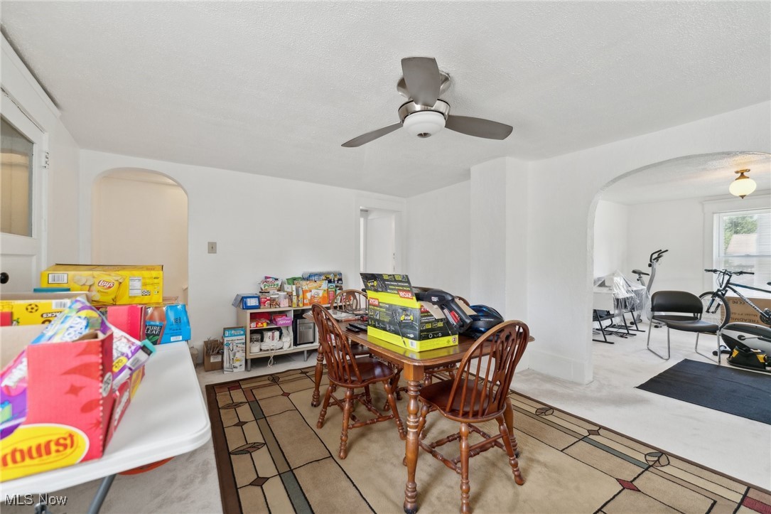 14631 Granger Road Maple Heights, OH 44137 - Photo 13 of 31 Dining room featuring light carpet, a textured ceiling, and ceiling fan