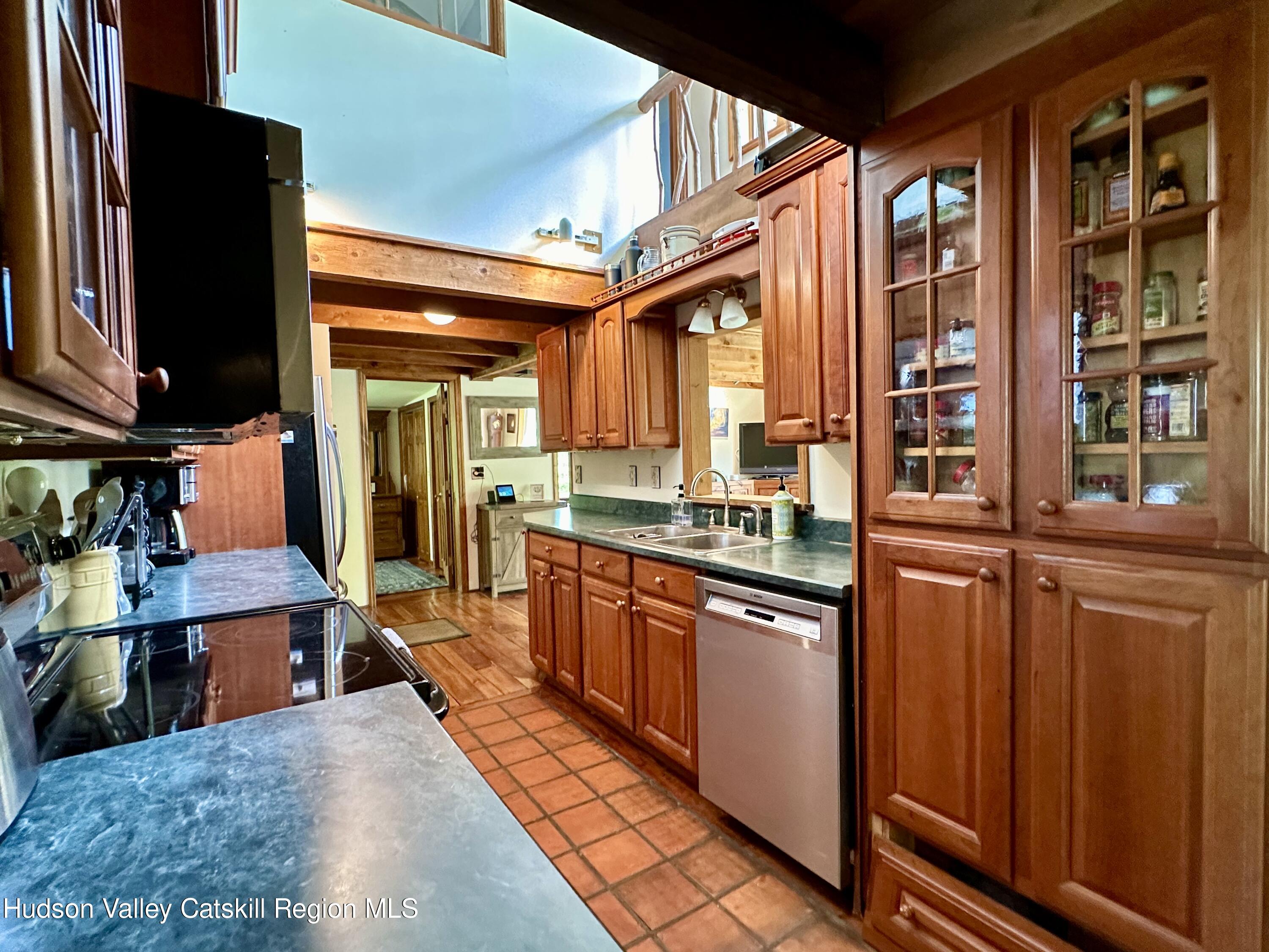 978 Scott Greene Road Roxbury, NY 12474 - Photo 13 of 41 a kitchen with stainless steel appliances granite countertop a refrigerator and wooden cabinets