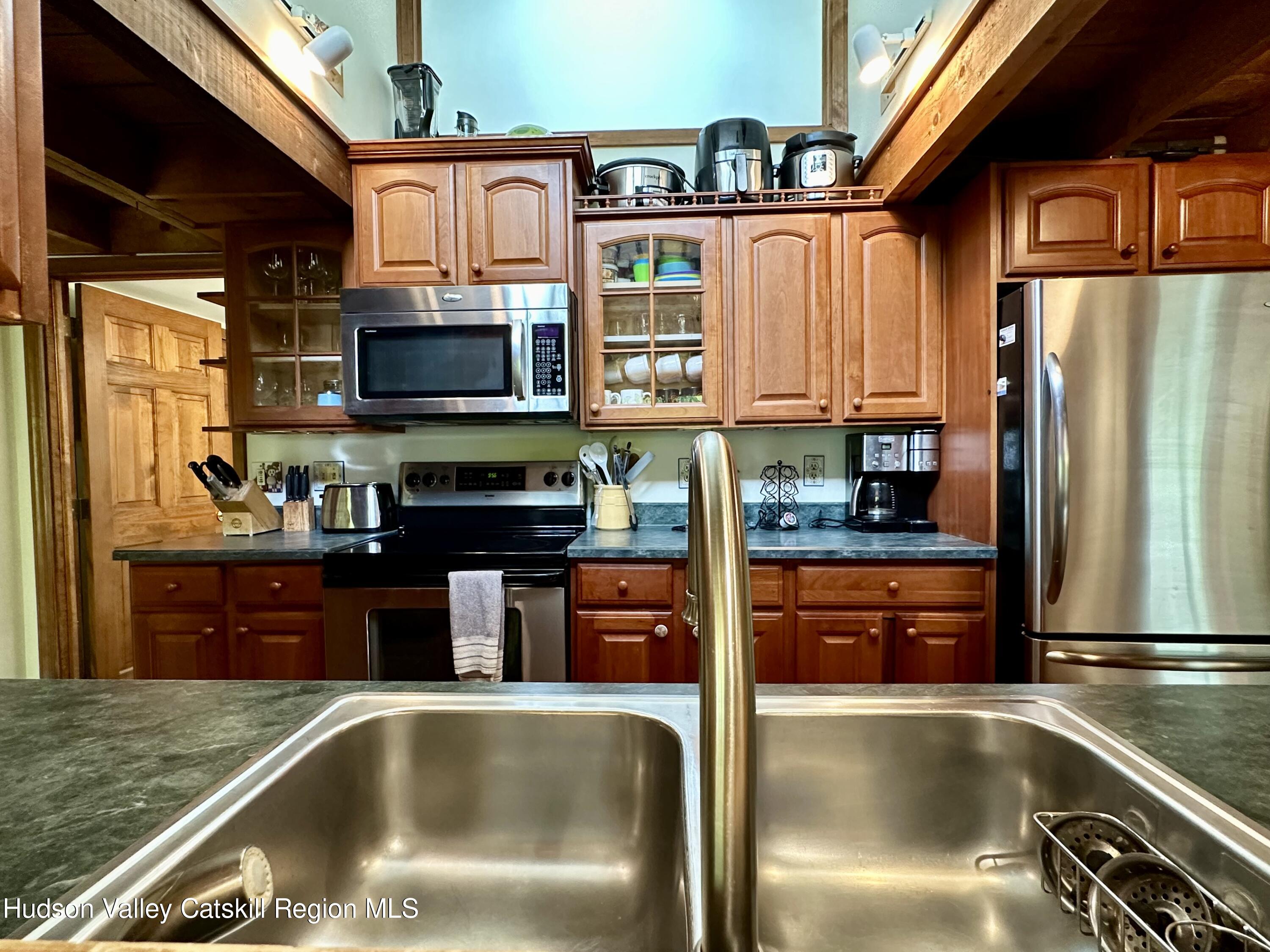 978 Scott Greene Road Roxbury, NY 12474 - Photo 14 of 41 a kitchen with stainless steel appliances granite countertop a refrigerator a stove top oven a sink and dishwasher