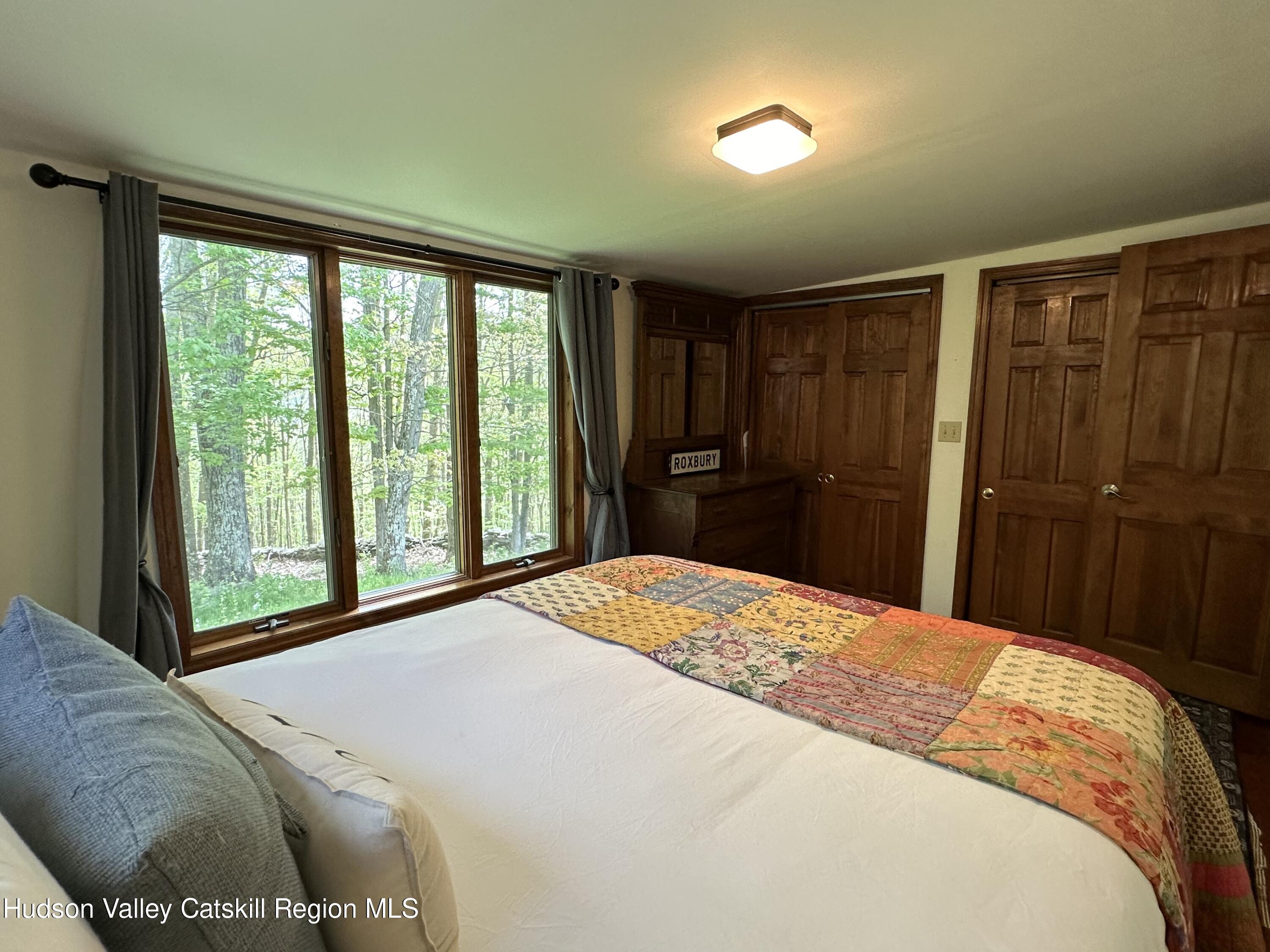 978 Scott Greene Road Roxbury, NY 12474 - Photo 18 of 41 a bedroom with a bed and a large window