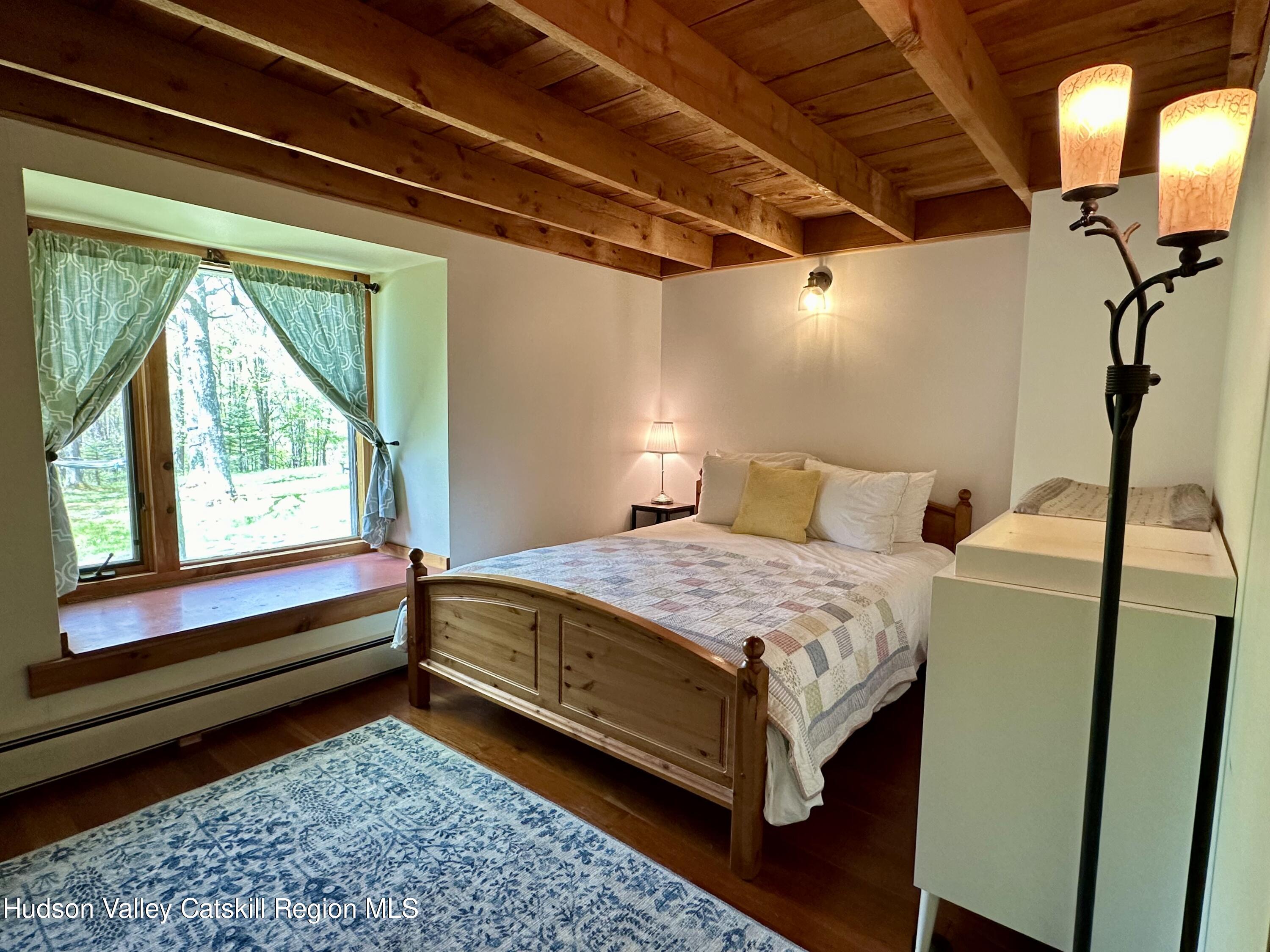 978 Scott Greene Road Roxbury, NY 12474 - Photo 19 of 41 a bedroom with a bed and wooden floor