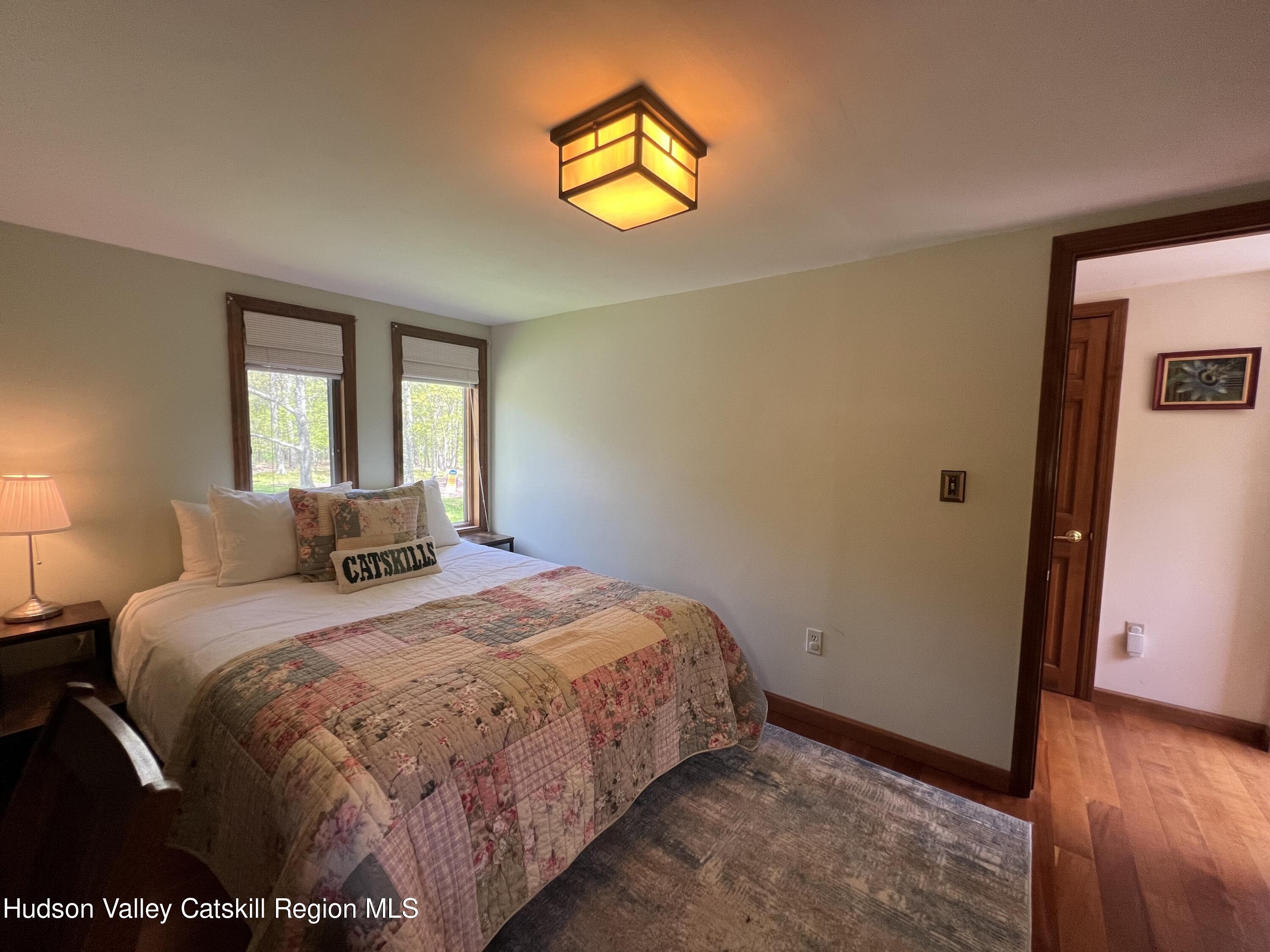 978 Scott Greene Road Roxbury, NY 12474 - Photo 20 of 41 a bedroom with a bed and wooden floor