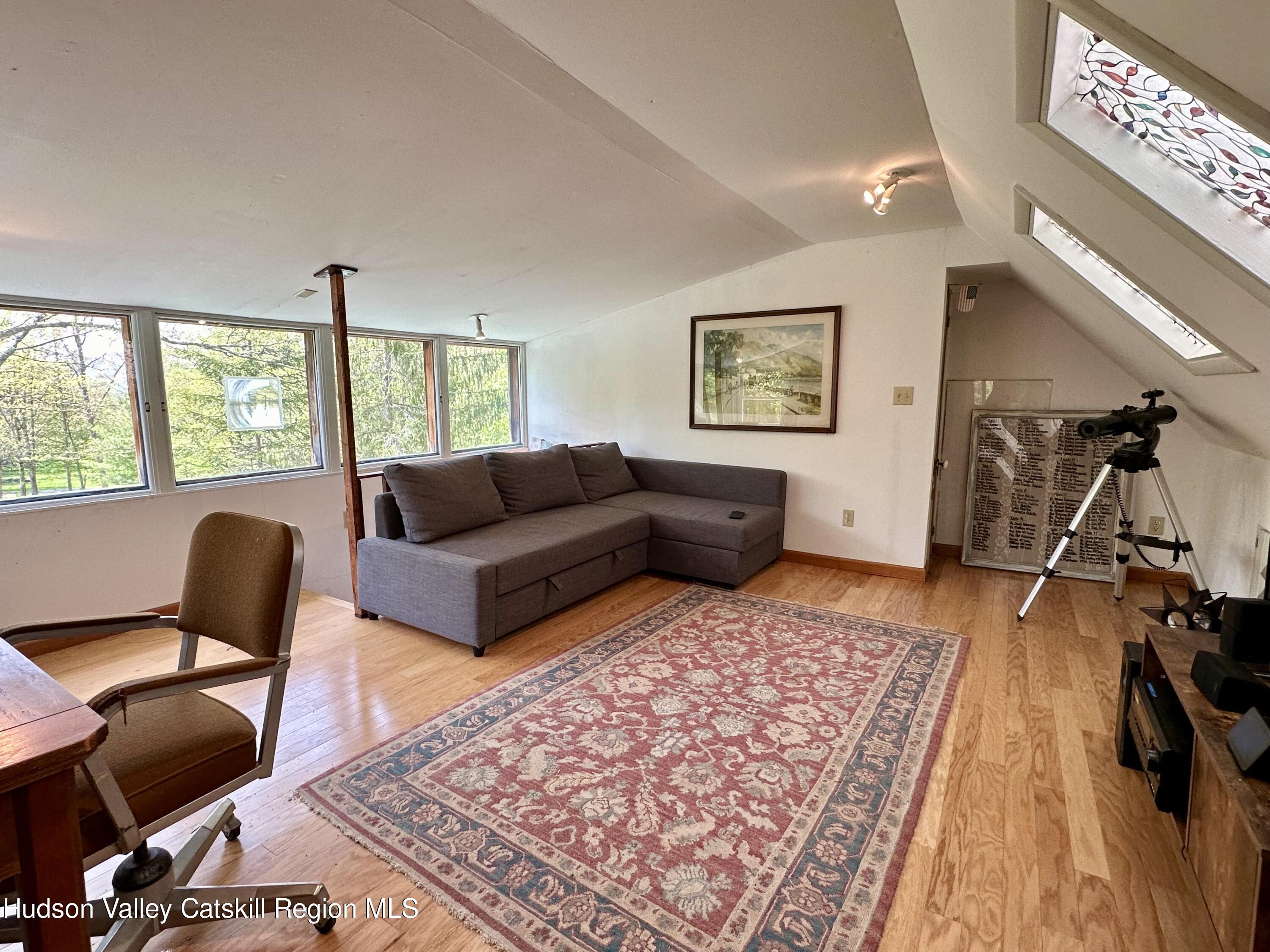 978 Scott Greene Road Roxbury, NY 12474 - Photo 32 of 41 a living room with furniture and a rug