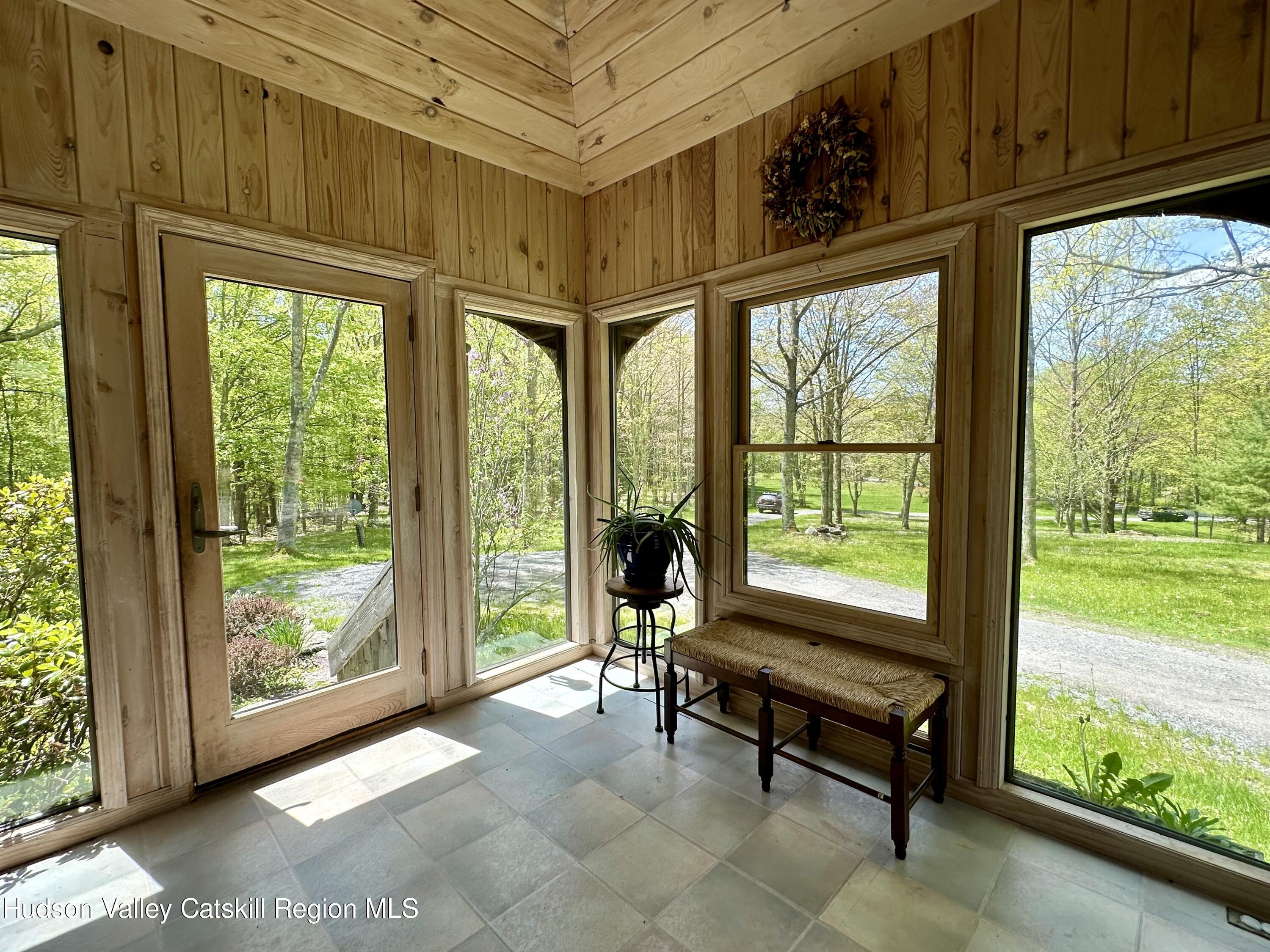978 Scott Greene Road Roxbury, NY 12474 - Photo 6 of 41 a living room with furniture tv and large windows
