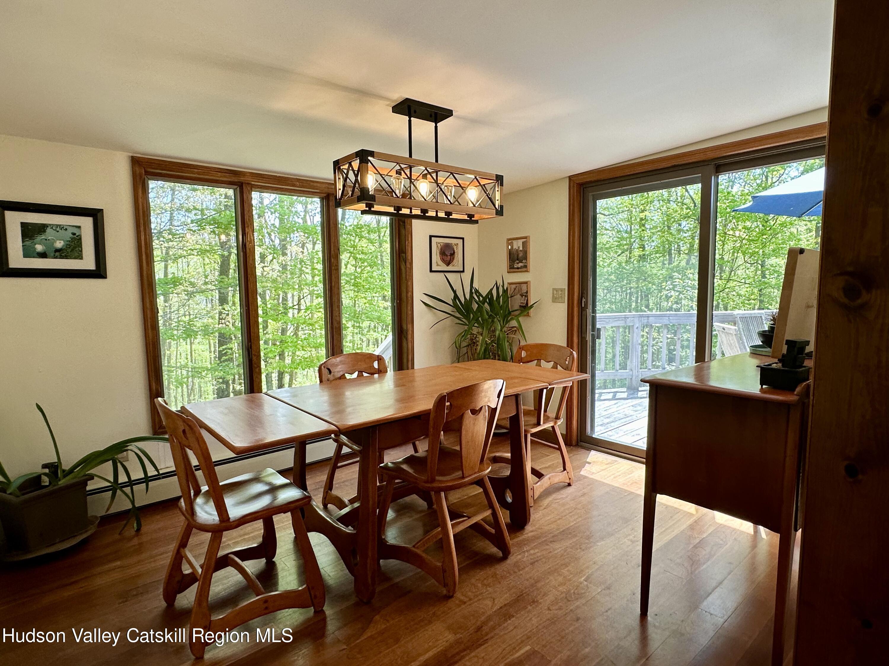 978 Scott Greene Road Roxbury, NY 12474 - Photo 10 of 41 a view of a dining room with furniture window and wooden floor