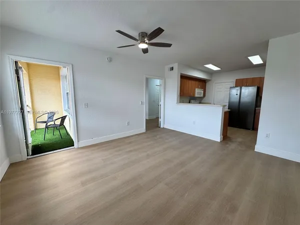 a view of a livingroom with a ceiling fan and window