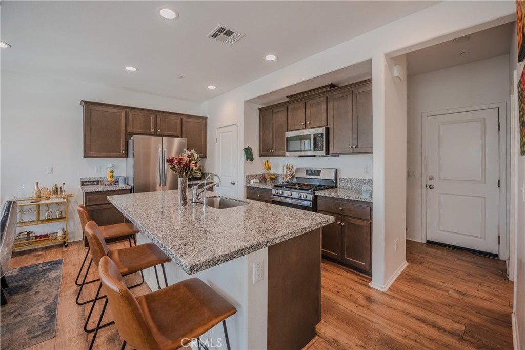 29486 Marx Way Winchester, CA 92596 - Photo 15 of 44 a kitchen with kitchen island a sink stove and refrigerator