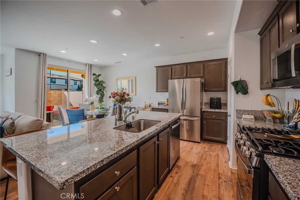 29486 Marx Way Winchester, CA 92596 - Photo 16 of 44 a kitchen with stainless steel appliances granite countertop a sink stove and refrigerator