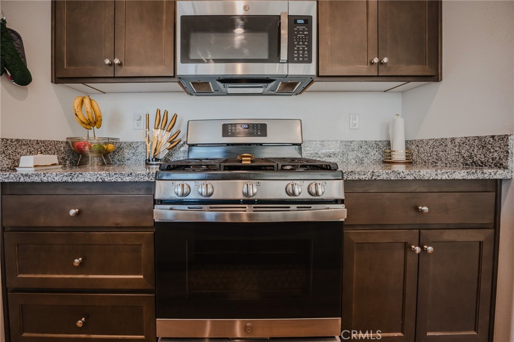 29486 Marx Way Winchester, CA 92596 - Photo 18 of 44 a kitchen with stainless steel appliances granite countertop a stove and a microwave