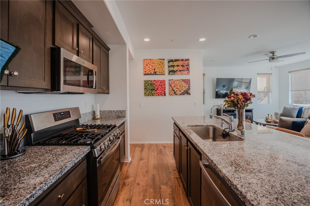 29486 Marx Way Winchester, CA 92596 - Photo 19 of 44 a kitchen with stainless steel appliances granite countertop a sink stove and refrigerator