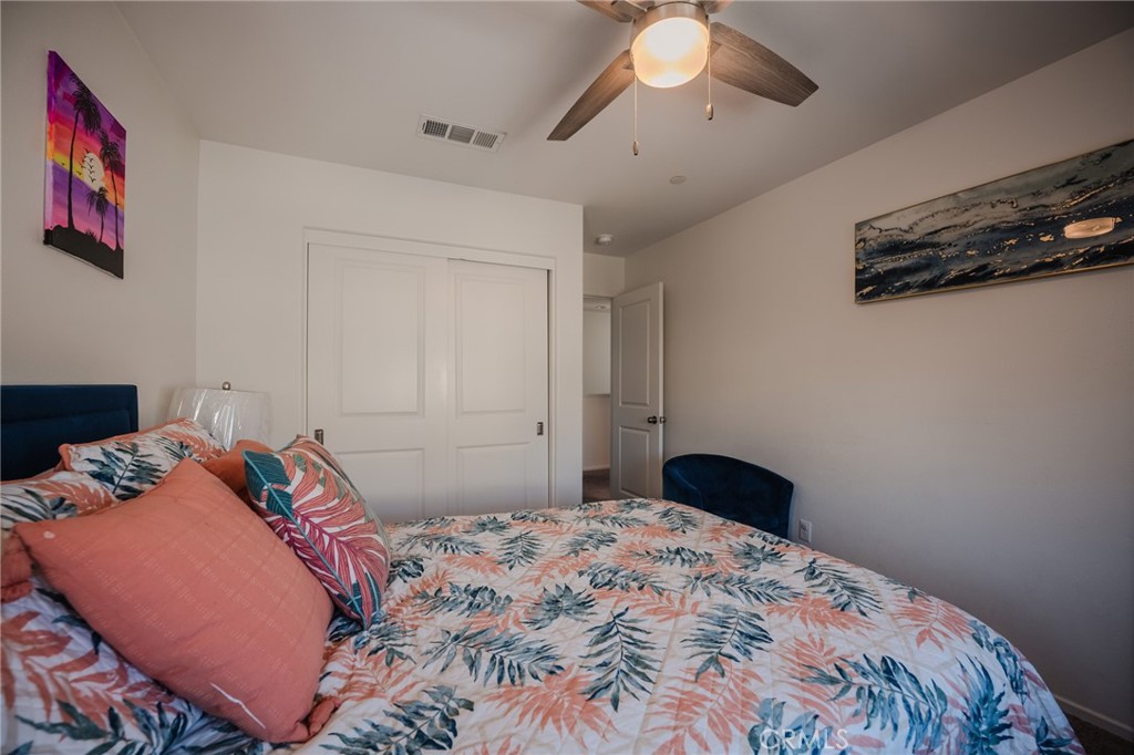 29486 Marx Way Winchester, CA 92596 - Photo 27 of 44 a bedroom with a bed and a chandelier