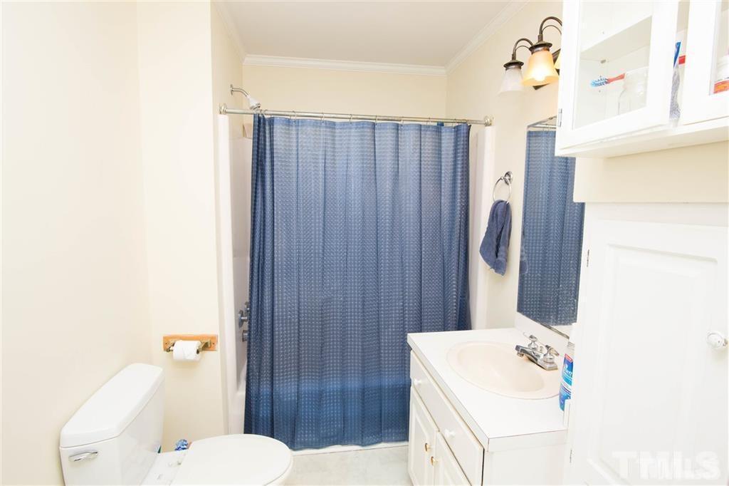 131 Justice Street Chapel Hill, NC 27516 - Photo 7 of 10 a bathroom with a sink a toilet and shower curtain