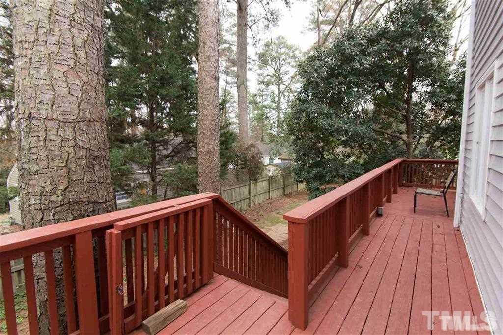 131 Justice Street Chapel Hill, NC 27516 - Photo 8 of 10 a balcony with wooden floor and trees