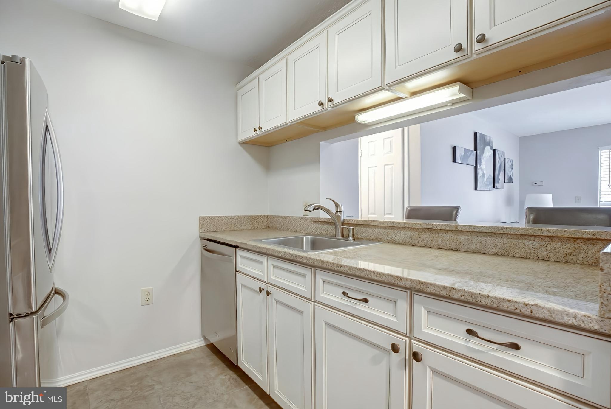 20950 Timber Ridge Terrace, Unit 202 Ashburn, VA 20147 - Photo 11 of 22 a kitchen with a sink and cabinets